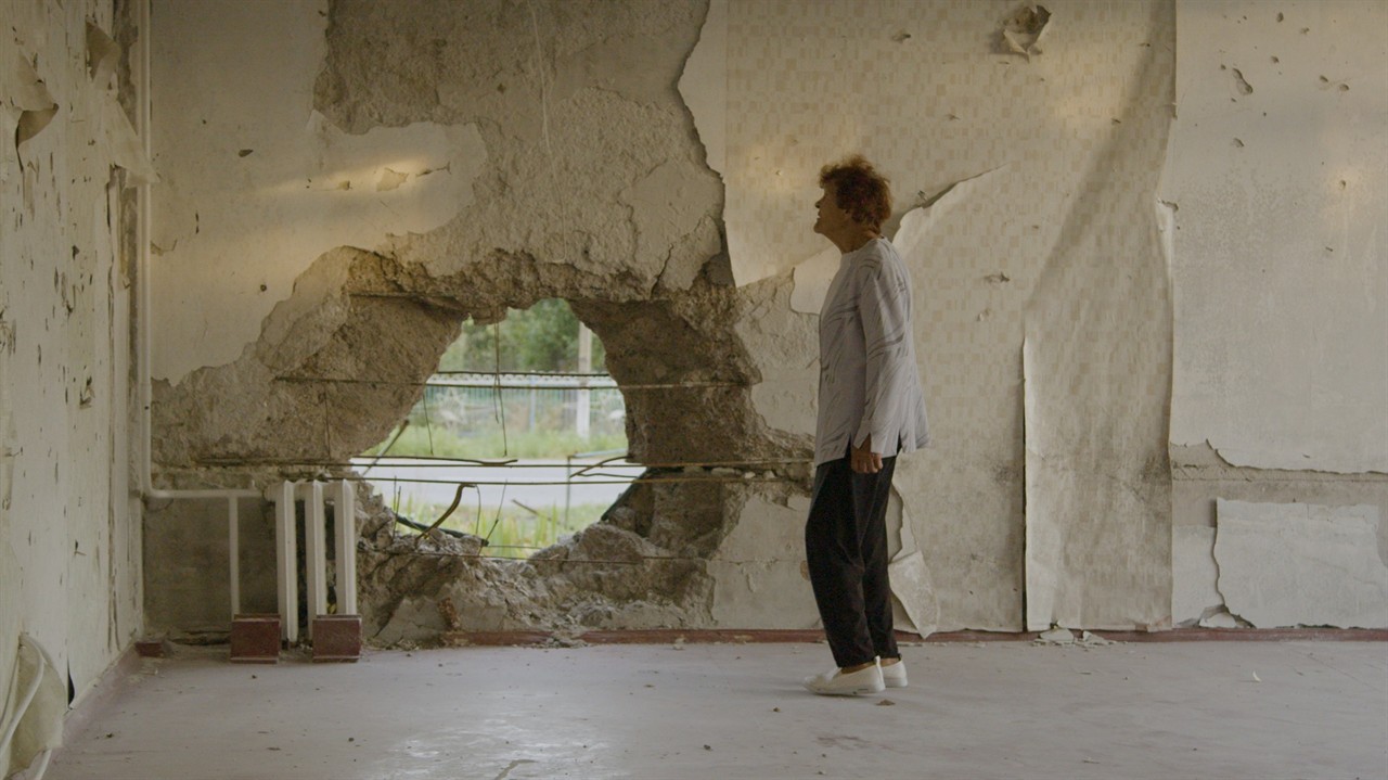 Man examining a hole in a concrete wall